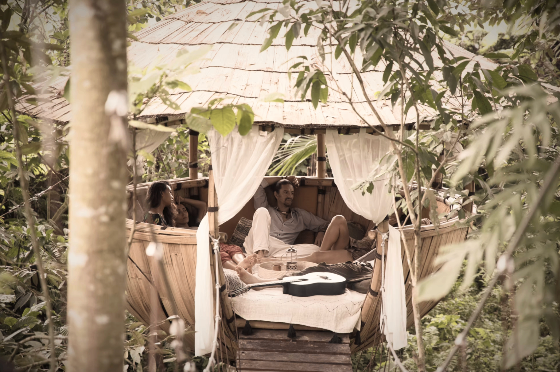 A secluded bamboo lounge in the jungle used for private late-night conversations