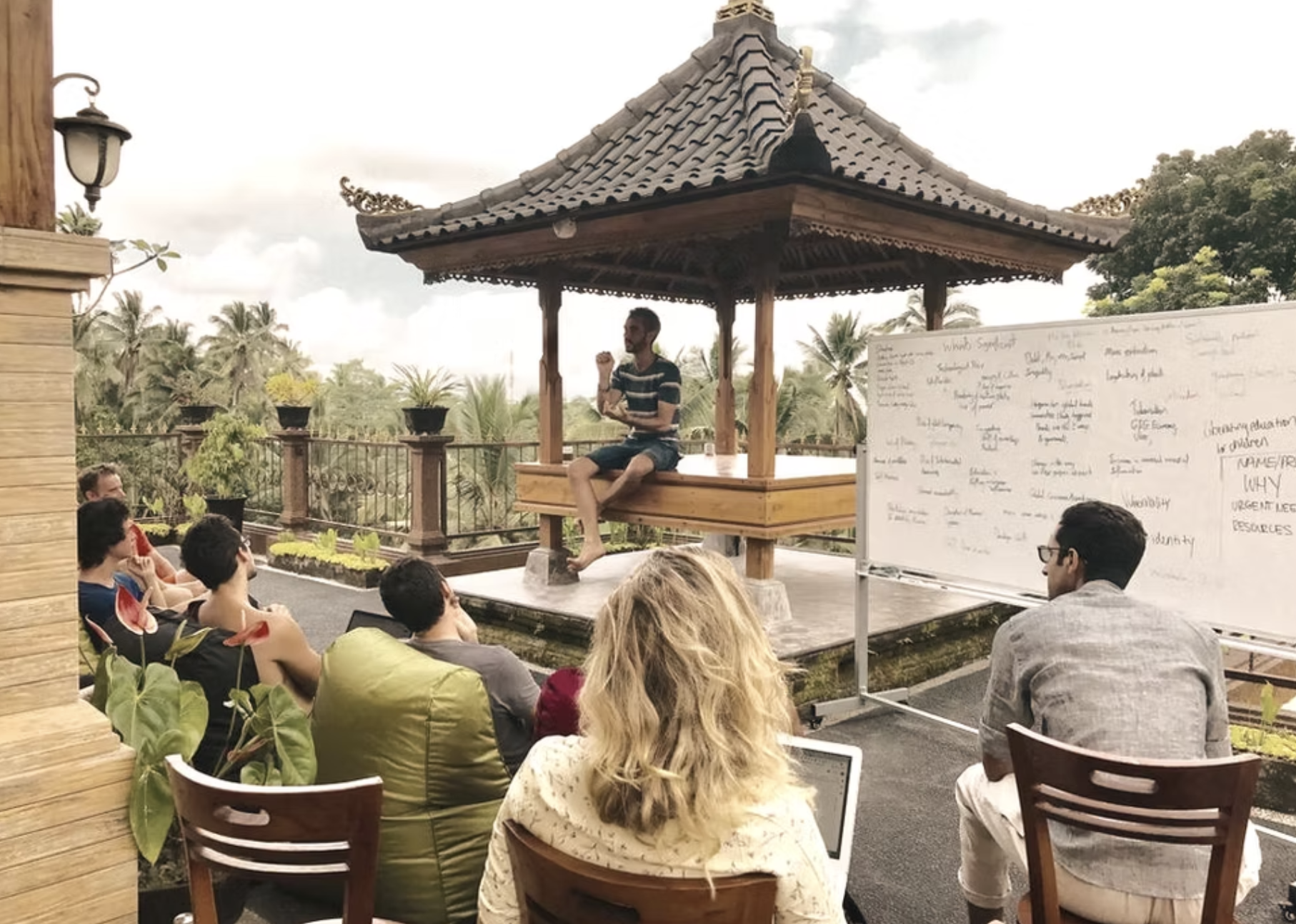 A protocol session in an open Balinese pavilion with whiteboard discussion