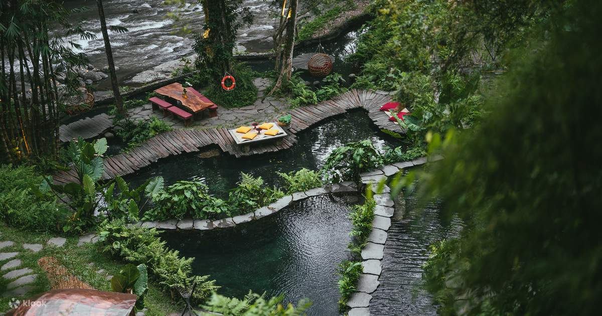 Spring-fed swimming pools along a river-side terrace