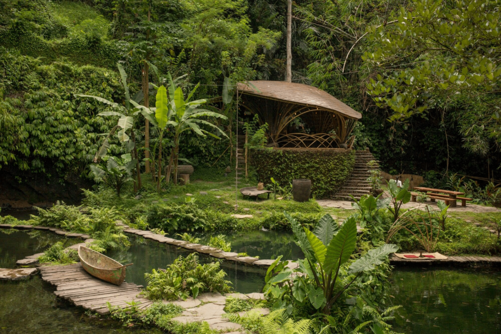 Bamboo pavilion above a lily pond surrounded by jungle